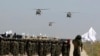 FILE - UH-60 Black Hawk helicopters fly during a military parade to mark the third anniversary of the withdrawal of U.S.-led troops from Afghanistan, in Bagram Air Base in the Parwan Province of Afghanistan, Aug. 14, 2024. 