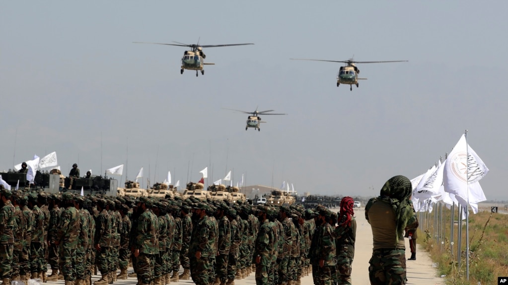 FILE - UH-60 Black Hawk helicopters fly during a military parade to mark the third anniversary of the withdrawal of U.S.-led troops from Afghanistan, in Bagram Air Base in the Parwan Province of Afghanistan, Aug. 14, 2024. 