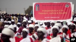 Southern Sudanese march and carry signs during a rehearsal for independence celebration, in the southern capital of Juba on Tuesday, July 5, 2011.