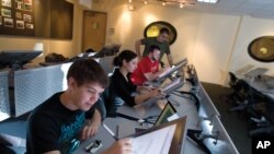 This undated photo provided by Full Sail University shows students working in one of the 110+ studios/labs on the Full Sail campus in Winter Park, Fla. 