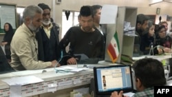 FILE - Afghan refugees submit documents at the Soleimankhani center for refugees in Tehran, Oct. 24, 2016.