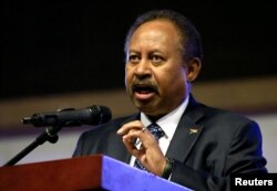 FILE - Sudan's Prime Minister Abdalla Hamdok speaks inside Friendship Hall in Khartoum, Sudan Dec. 25, 2019.