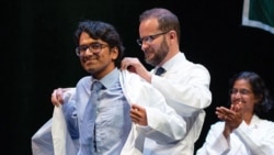 Syed Rakin Ahmed receives his white coat during a medical school ceremony.