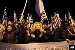 FILE - Supporters of Greece's extreme right party Golden Dawn attend a rally commemorating a 1996 military incident which cost the lives of three Greek navy officers and brought Greece and Turkey to the brink of war, in Athens, on Saturday, Jan. 28, 2017.