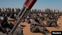 FILE: South Sudan People's Defence Forces (SSPDF), South Sudan Opposition Alliance (SSOA), and The Sudan People's Liberation Movement in Opposition (SPLM-IO) soldiers gather in Gorom outside Juba, South Sudan. Taken 2.17.2020