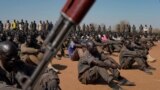 FILE: South Sudan People's Defence Forces (SSPDF), South Sudan Opposition Alliance (SSOA), and The Sudan People's Liberation Movement in Opposition (SPLM-IO) soldiers gather in Gorom outside Juba, South Sudan. Taken 2.17.2020