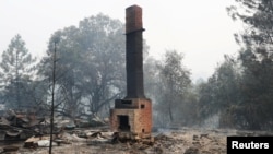 A chimney is all that is left of a home destroyed by the Detwiler fire in Mariposa, California U.S., July 19, 2017. 