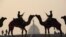 Indian soldiers ride camels during a rehearsal for the 'Beating the Retreat' ceremony in New Delhi ahead of India's Republic Day celebrations.