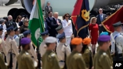 US President Donald Trump, background centre left and first lady Melania Trump participate in an arrival ceremony at Ben Gurion International Airport, May 22, 2017.