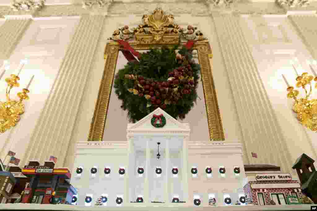 A White House gingerbread house sits in the State Dining Room during a press preview of the White House holiday decorations, Monday, Nov. 29, 2021, in Washington. (AP Photo/Evan Vucci)