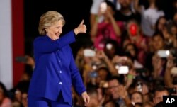 FILE - Democratic presidential candidate Hillary Clinton gives a thumbs up to supporters as she arrives for a campaign rally in Tempe, Arizona, Nov. 2, 2016.