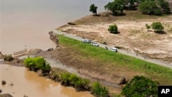 Aerial views shows a road that has been washed away by flood waters in Chokwe, Mozambique, Jan. 30, 2013.