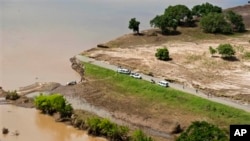 Aerial views shows a road that has been washed away by flood waters in Chokwe, Mozambique, January 30, 2013.