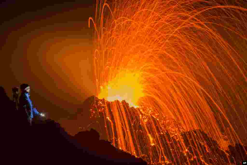 A person looks at the Piton de la Fournaise volcano erupting, Feb. 5, 2015, on the French Indian Ocean island of La Reunion.&nbsp; This is the second eruption in the past year at Piton de la Fournaise after three years of quiet.