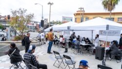 People wait for COVID-19 vaccines in the Thai CDC Free Covid-19 Vaccination Clinic at East Hollywood Farmer’s Market, Los Angeles, CA.