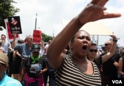 FILE - Demonstrators take part in a protest against President Jacob Zuma march across the Nelson Mandela bridge into Johannesburg, Dec. 16, 2015.