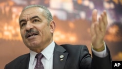 Palestinian Prime Minister Mohammad Shtayyeh italks during an interview with The Associated Press, at his office in the West Bank city of Ramallah, April 16, 2019. 