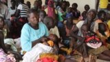 South Sudanese refugees wait at a health center in Maaji settlement, Adjumani district, northern Uganda, June 14, 2017. (H. Athumani/VOA)