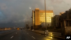 FILE - The setting sun shines on the facade of the United States Embassy, in Havana, Cuba, Oct. 14, 2017. Canada has no plans to remove its diplomats from Cuba, despite symptoms of potential illness among its diplomatic corps.