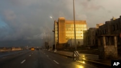 FILE - Rays from the setting sun shine on the facade of the United States Embassy, in Havana, Cuba, Oct. 14, 2017.