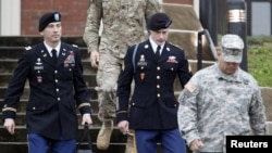 FILE - U.S. Army Sergeant Bowe Bergdahl, second from right, leaves the courthouse with his defense attorney, Lieutenant Colonel Franklin Rosenblatt, left, after an arraignment hearing for his court-martial in Fort Bragg, N.C., Dec. 22, 2015.
