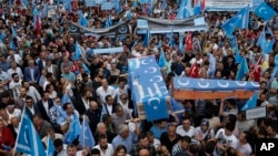 FILE - Uighurs living in Turkey and their supporters, some carrying coffins representing Uighurs who died in China's far-western Xinjiang region, chant slogans as they stage a protest in Istanbul against China's oppression of Muslim Uighurs.