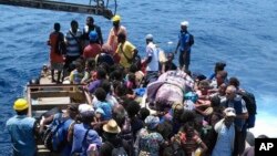 Residents wait on a raft to board a boat as they are evacuated from the Pacific island of Ambae, which is part of Vanuatu on Wednesday Sept. 27, 2017.