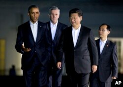 U.S. President Barack Obama, left, walks with Chinese counterpart Xi Jinping, front right, outside the White House in Washington, Sept. 24, 2015.
