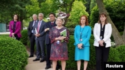 FILE - Members of the White House staff stand in the Rose Garden of the White House, May 13, 2021.