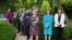 FILE - Members of the White House staff stand in the Rose Garden of the White House, May 13, 2021.