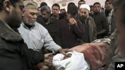 Palestinian relatives gather around the body of a Hamas militant killed in an Israeli air strike on a Hamas training camp, during his funeral in a mosque in Gaza City, March 16, 2011