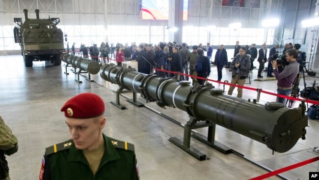Russian military officers stand by as the 9M729, center, its launcher, left, and the 9M728, right, land-based cruise missiles are displayed in Kubinka outside Moscow, Russia, Jan. 23, 2019.