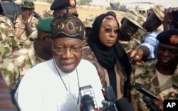 In this image taken from video, Lai Muhammed, Nigerian Minister of Information, speaks to the media in Dapchi, Yobe State, Nigeria, Feb. 22, 2018.