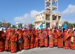 FILE - Somali women shout slogans during a demonstration against the maritime border dispute with Kenya, in Mogadishu, Somalia Sept. 21, 2016.