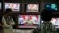People watch Indian Prime Minister Narendra Modi addressing the nation, on television in Hyderabad, India, Saturday, Dec. 31, 2016. 