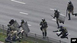 Belarusian riot police detain a demonstrator during an opposition rally to protest the official presidential election results in Minsk, Belarus, Nov. 15, 2020.