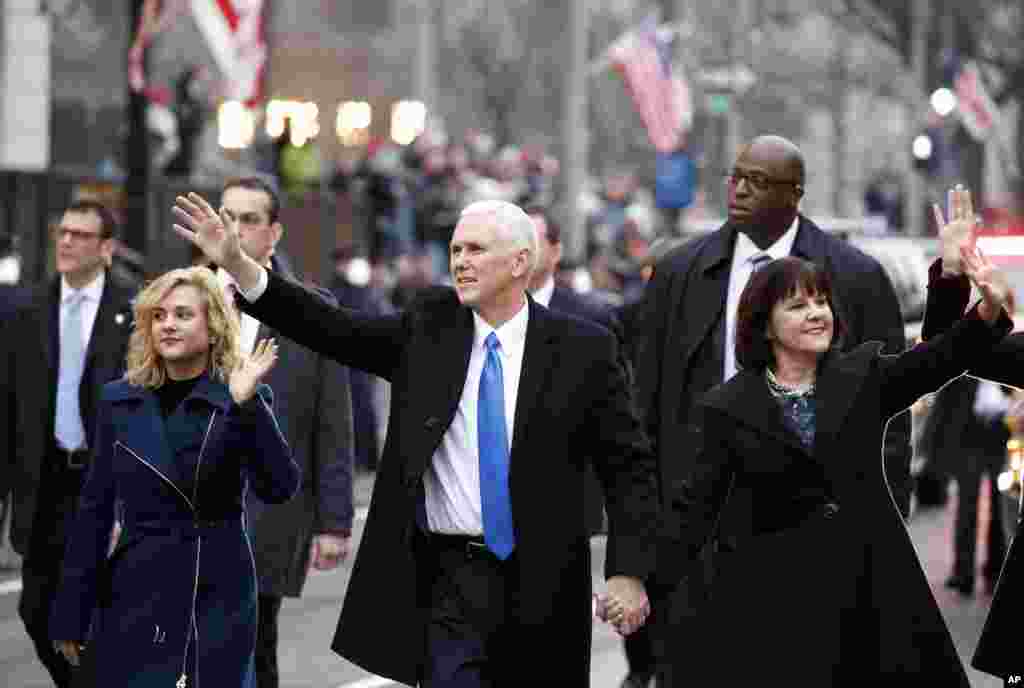 Vice President Mike Pence walks in the inauguration parade with his wife, Karen, and daughter Charlotte, left, in Washington, Jan. 20, 2017.