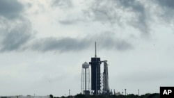 Clouds pass over the SpaceX Falcon 9, with the Crew Dragon spacecraft on top of the rocket, as it sits on Launch Pad 39-A Wednesday, May 27, 2020, at Kennedy Space Center in Cape Canaveral, Fla. (AP Photo/David J. Phillip)