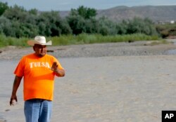 Navajo Nation Council Delegate Davis Filfred walks along the San Juan River, Aug. 11, 2015, in Montezuma Creek, Utah.