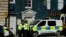 Police officers stand outside a Zizzi restaurant in Salisbury, England, Wednesday, March 7, 2018, near to where former Russian double agent Sergei Skripal was found critically ill.