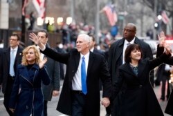 FILE - Vice President Mike Pence walks in the inauguration parade with his wife, Karen, and daughter Charlotte, left, in Washington, Jan. 20, 2017.