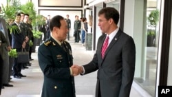 Chinese Defense Minister Wei Fenghe, left, greets U.S. Defense Secretary Mark Esper in Bangkok, Thailand, Nov. 18, 2019. 