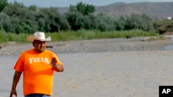 Navajo Nation Council Delegate Davis Filfred walks along the San Juan River, Aug. 11, 2015, in Montezuma Creek, Utah. 
