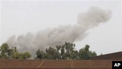 A smoke plume rises into the sky over Tripoli, Libya, on June 7, 2011 following an airstrike