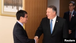 U.S. Secretary of State Mike Pompeo shakes hands with Japan's Foreign Minister Taro Kono before a meeting in Tokyo, Japan, Oct. 6, 2018. 