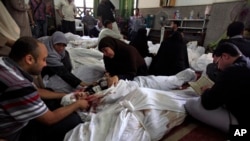 Egyptians mourn over the bodies of their relatives in the El-Iman mosque, Nasr City, Cairo, Egypt, Aug. 15, 2013.