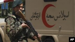 An Afghan soldier patrols outside a hospital in Kabul