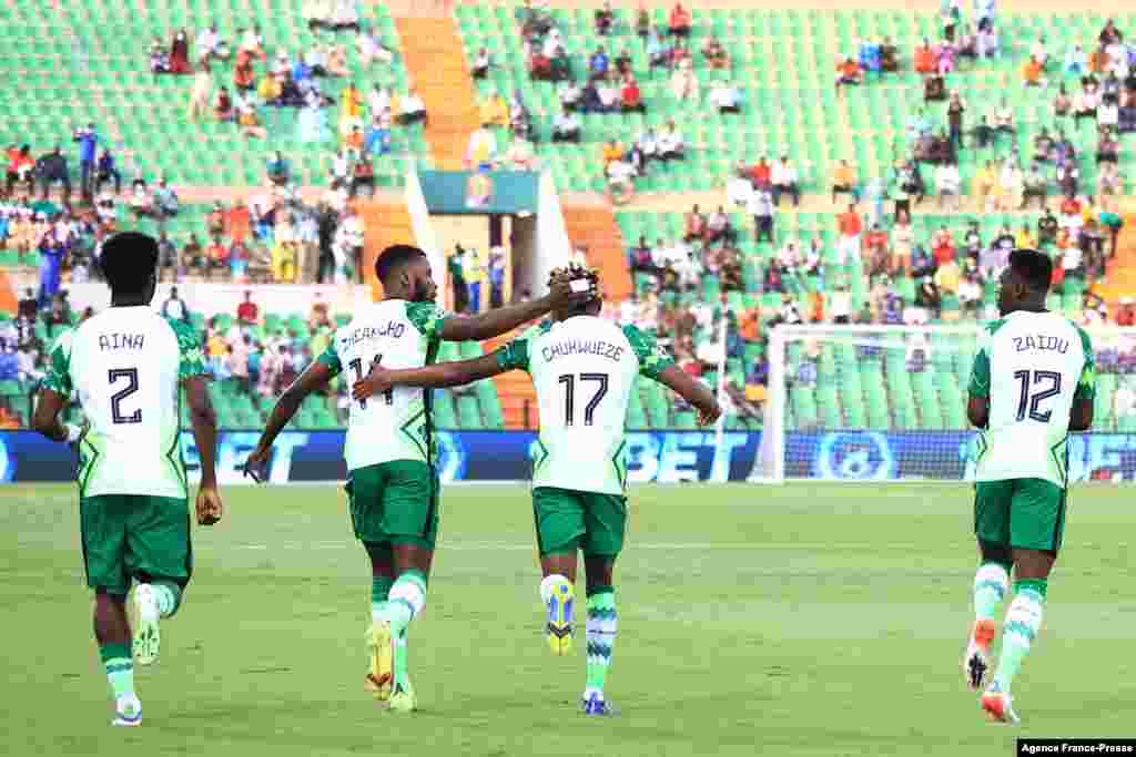 Nigeria&#39;s forward Samuel Chukwueze (C) celebrates with teammates after scoring the opening goal during the football match between Nigeria and Sudan.