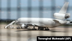 Zimbabwean armed soldiers patrol around a United States registered cargo plane at Harare International Airport in Harare, Zimbabwe, Monday, Feb,15.2016. (AP Photo/Tsvangirayi Mukwazhi)