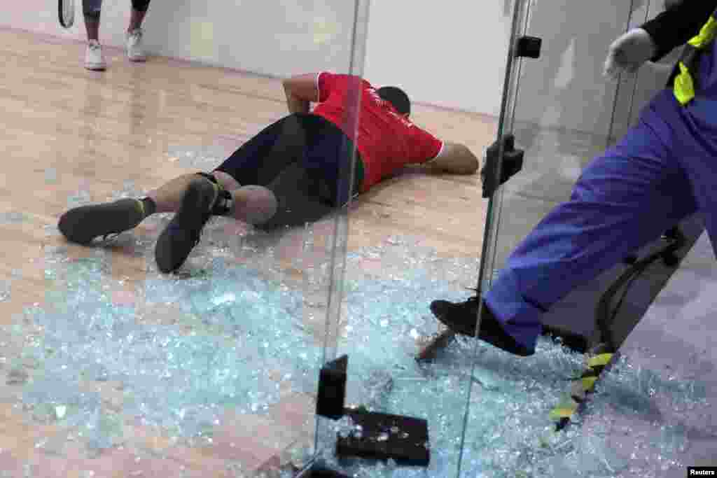Mexico&#39;s Alvaro Beltran lies on the court after shattering a glass panel of the racquetball court during his Gold Medal Match against Rodrigo Montoya, also of Mexico, at the Pan American Games in Lima, Peru, Aug. 7, 2019.